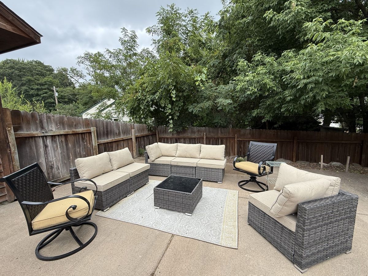 Backyard patio lounge set inside the fenced yard